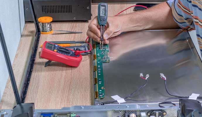 professional worker restoring electronics device