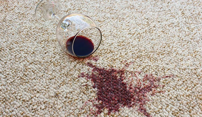 spilled wine glass on carpet with visible stain