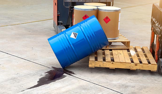 chemical spilling on the ground from a chemical container