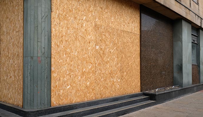 A building with boarded-up window