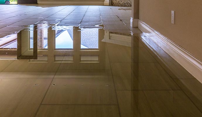 A room with a tiled floor was partially flooded with water