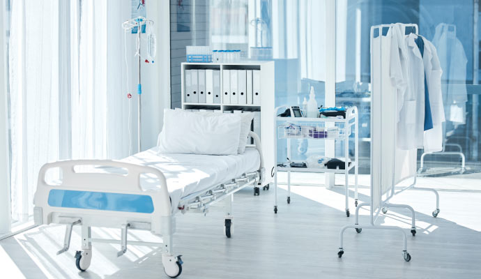 a hospital room with bed, equipments and accessories