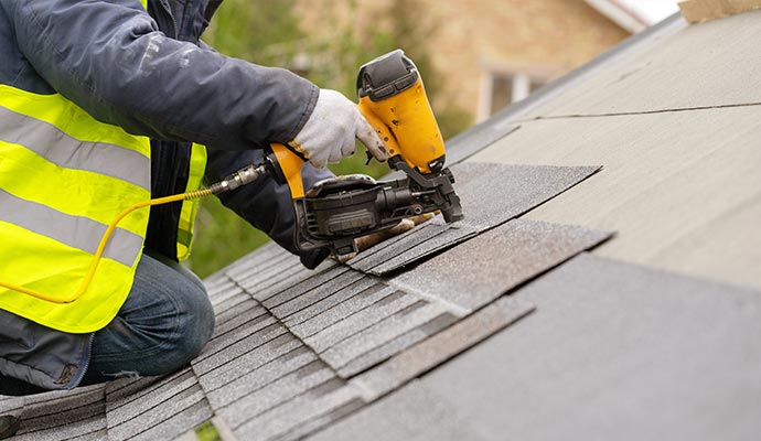 a professional replacing roof