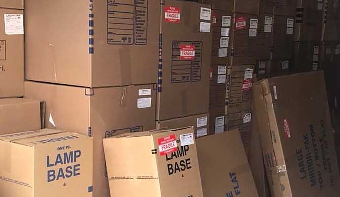 A storage area full with cardboard boxes representing pack-out service