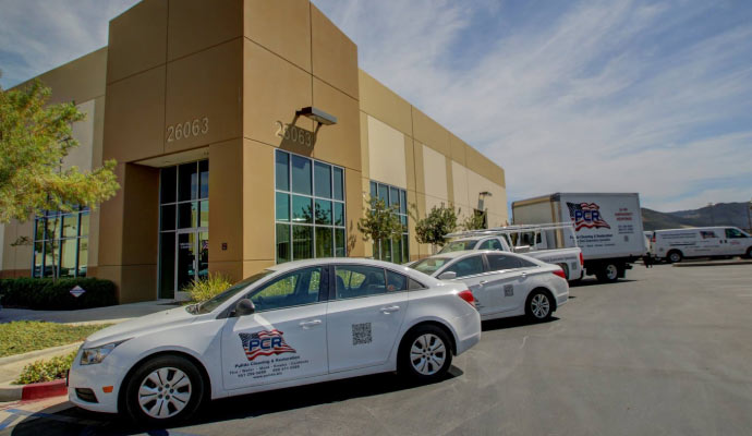 Teampulido restoration vehicles in front of a commercial building 