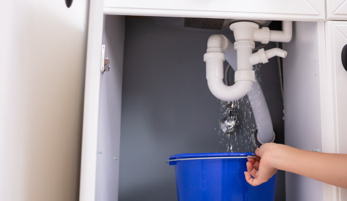 water leaking out of an overflowing plumbing