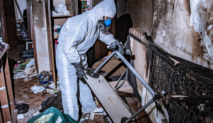 a person performing restoration service in a fire damaged area