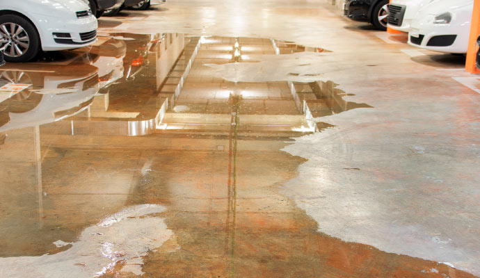 a garage floor with noticeable water damage