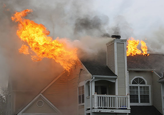 house burning with fire coming outside