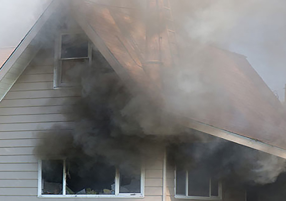 house burning with smoke coming outside