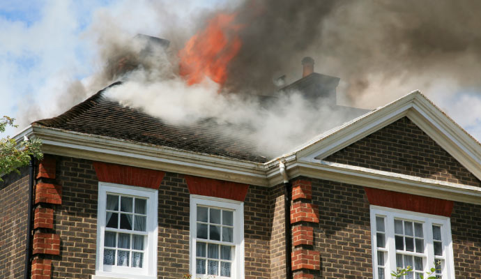 smoke coming out from a fire damaged house