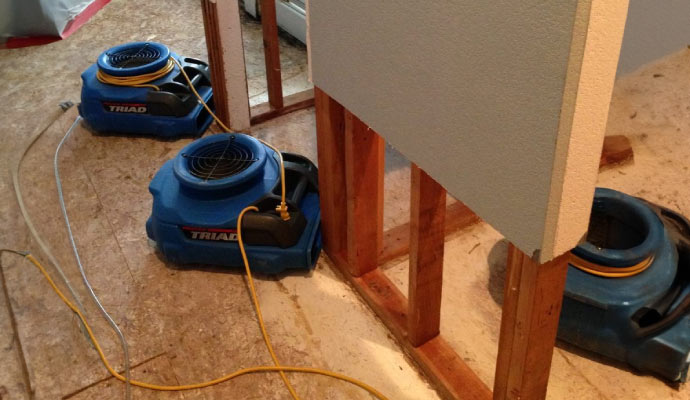 an indoor setting where water damage restoration is in progress