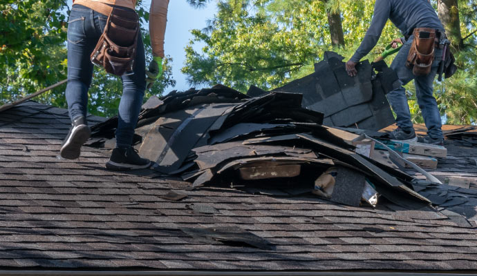 Professional team restoring damaged roof