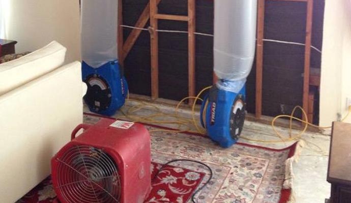 professional water damage restoration using equipments