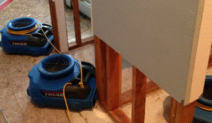 professional floor water damage restoration using equipments