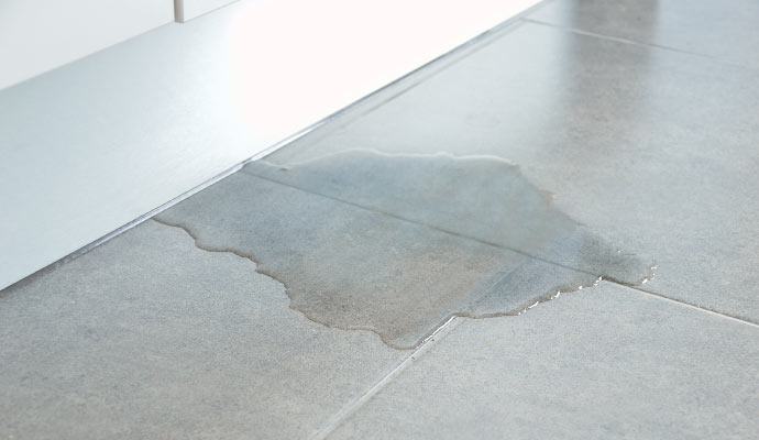 a tiled floor with noticeable water damage